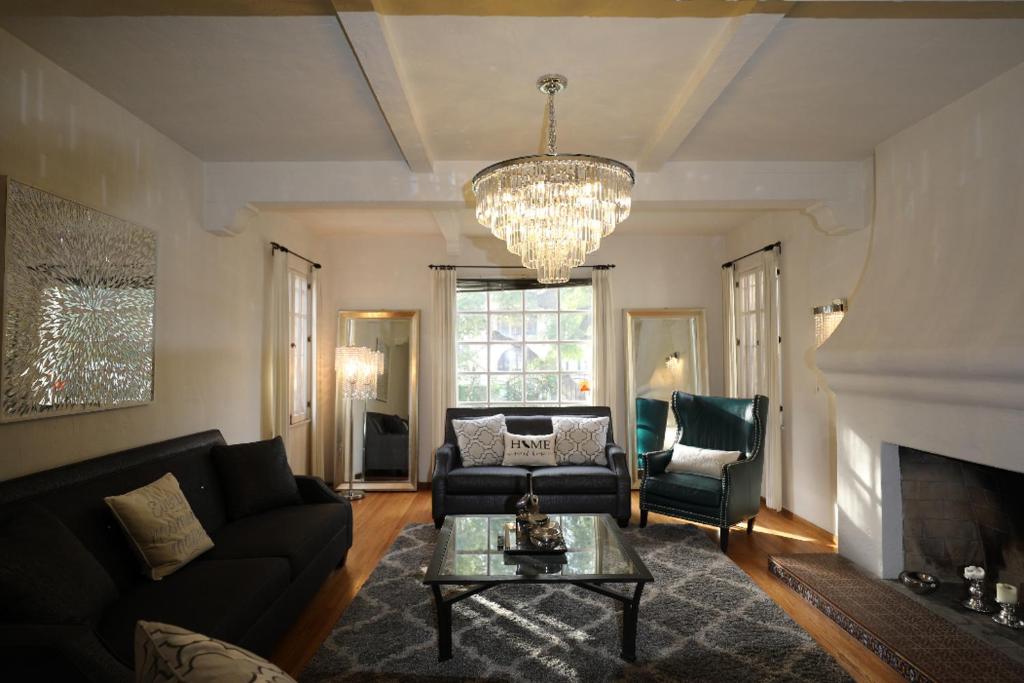 a living room with a couch and a chandelier at Renovated Spanish 3BD 2BA near Beverly Hills in Los Angeles