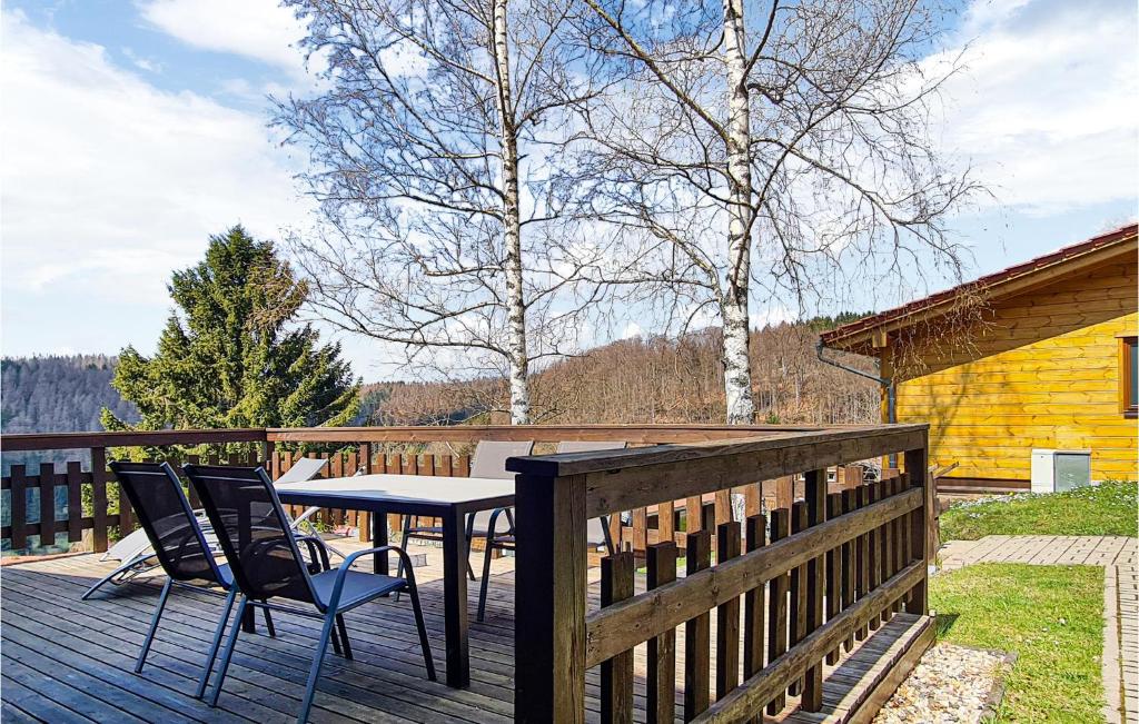 a patio with a table and chairs on a deck at 2 Bedroom Lovely Home In Masserberg Ot Fehrenba in Fehrenbach