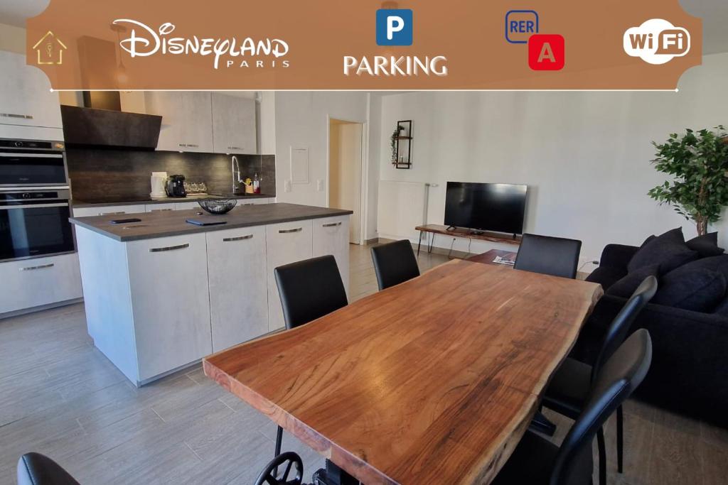 a kitchen and dining room with a wooden table at Appartement Chic Gold - 5min Disneyland in Serris