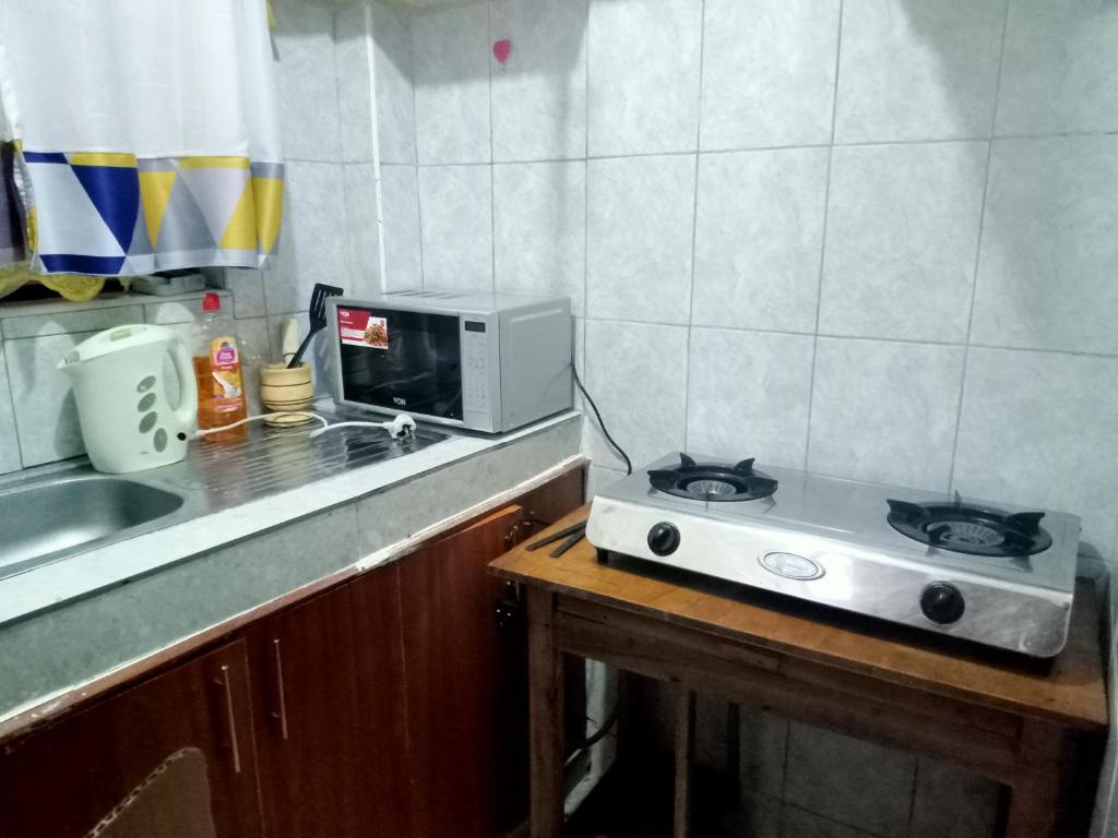 a microwave sitting on a counter in a kitchen at MASONKO Luxury Homes - Kakamega in Kakamega
