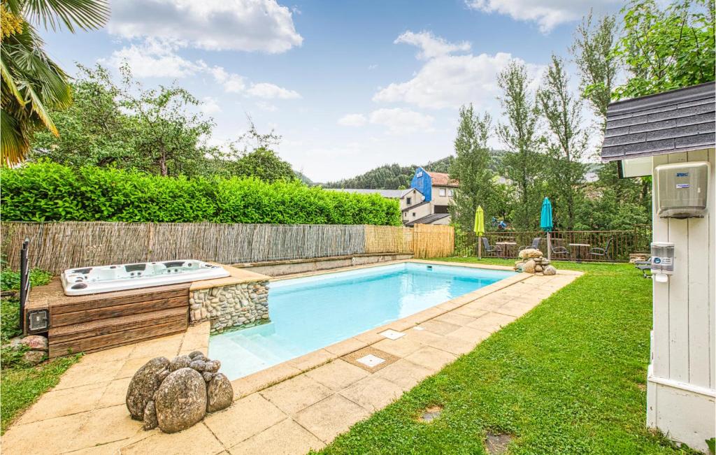 a backyard with a swimming pool and a fence at Cozy Apartment In Saint Jean Du Bruel With Private Swimming Pool, Can Be Inside Or Outside in Saint-Jean-du-Bruel
