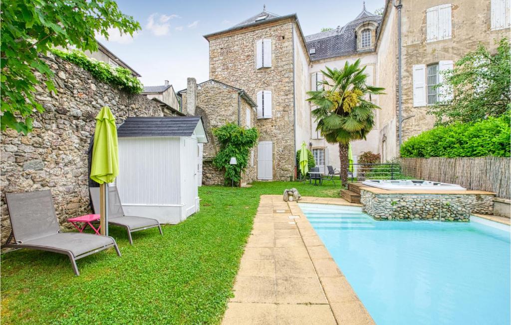 a backyard with a swimming pool and a house at Cozy Apartment In Saint Jean Du Bruel With Private Swimming Pool, Can Be Inside Or Outside in Saint-Jean-du-Bruel