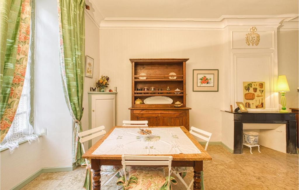 a dining room with a table and a fireplace at Cozy Apartment In Saint Jean Du Bruel With Private Swimming Pool, Can Be Inside Or Outside in Saint-Jean-du-Bruel