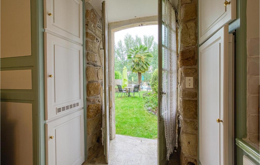 an open door with a view of a yard at Cozy Apartment In Saint Jean Du Bruel With Private Swimming Pool, Can Be Inside Or Outside in Saint-Jean-du-Bruel