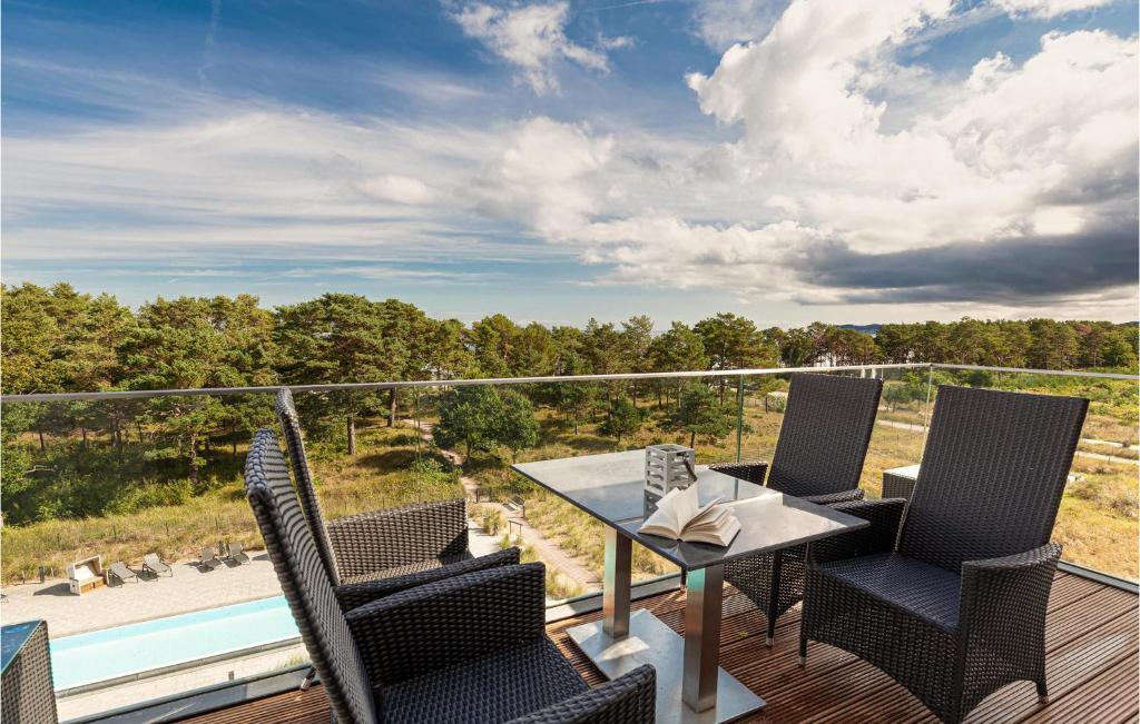 a patio with a table and chairs on a deck at Skysuite in Binz