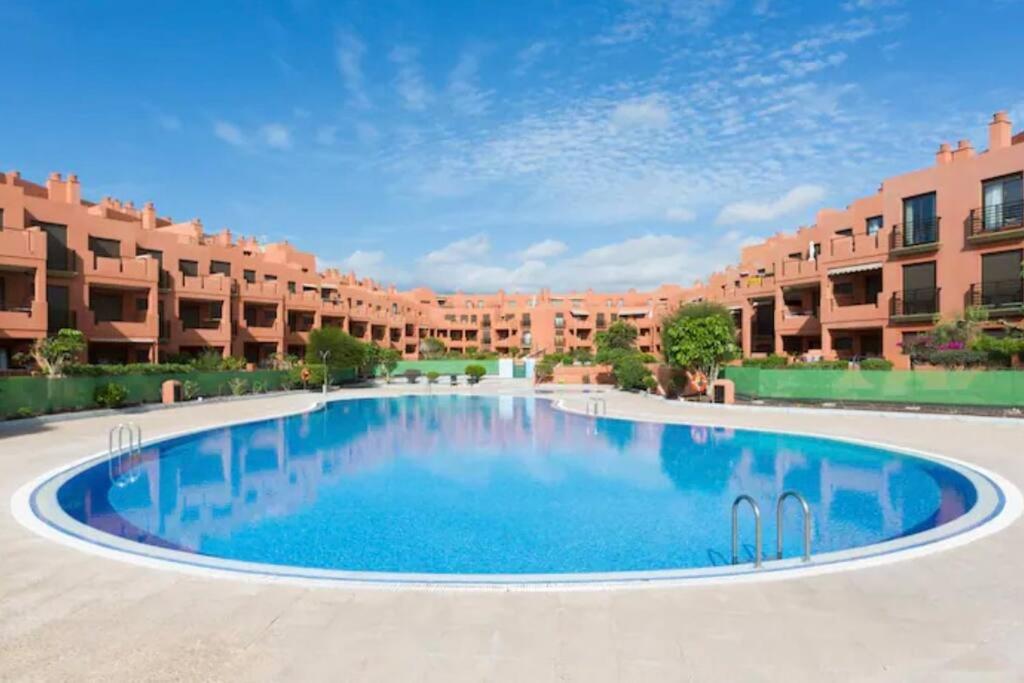 a large swimming pool in front of a large apartment building at Apartment in La Tejita 2 in La Tejita