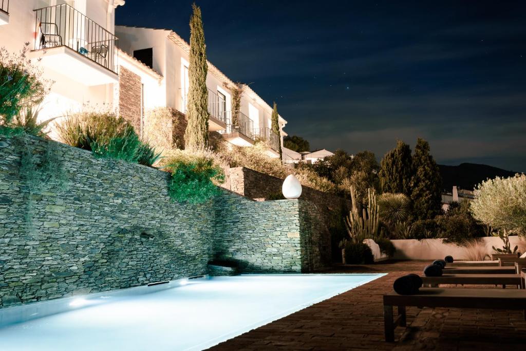 een zwembad voor een gebouw 's nachts bij Boutique Hotel Villa Gala in Cadaqués