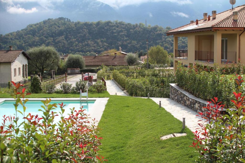 a house with a yard with a swimming pool at Via Volta Lenno in Tremezzo