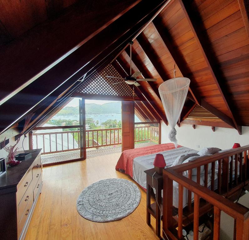 a bedroom with a bed and a large window at Harbour View House in Port Elizabeth