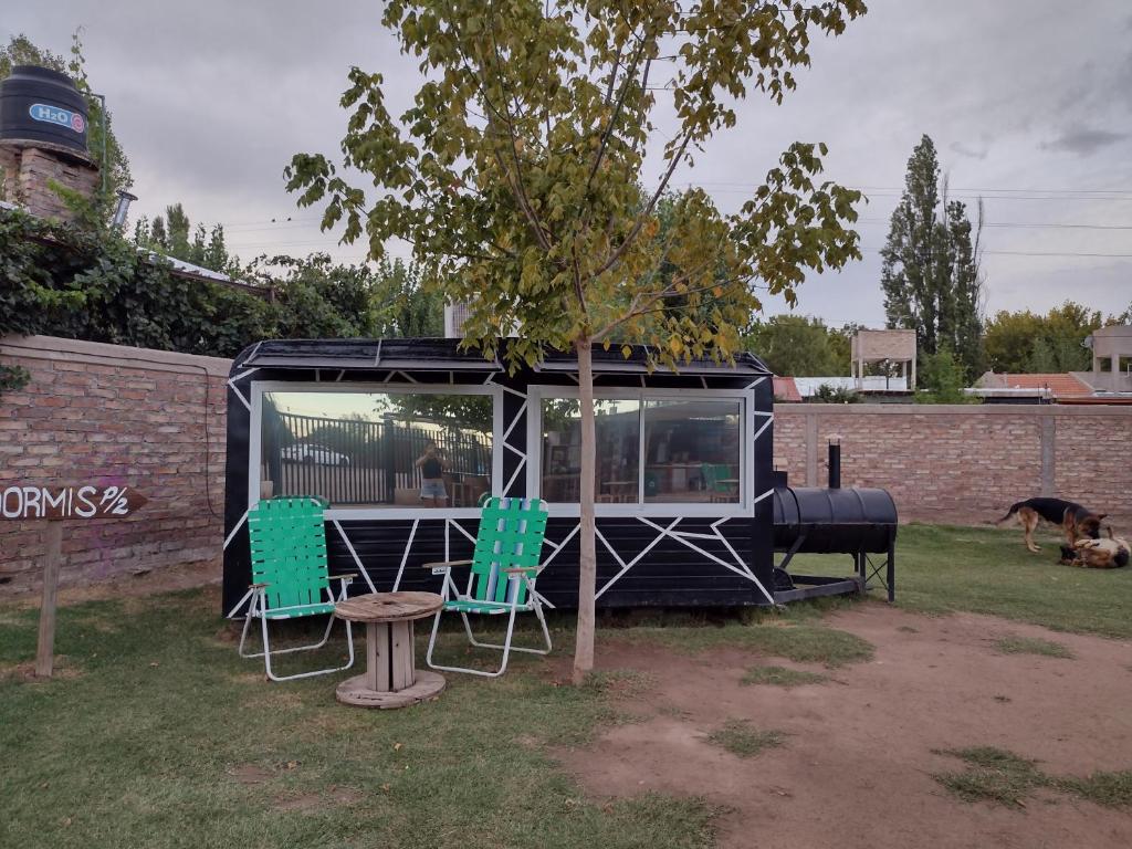 a tiny house with two chairs and a table at DORMIS P/2 in Ciudad Lujan de Cuyo