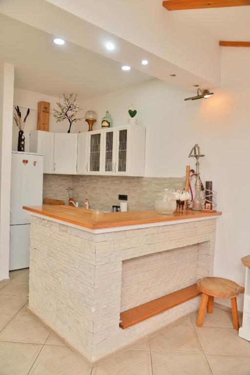 a kitchen with a large island in the middle at Apartman Teo in Požarevac