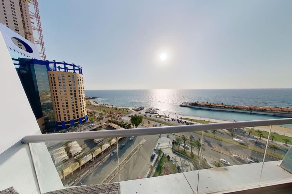 a view of the ocean from the balcony of a building at شقة في برج داماك بإطلالة بحرية ساحرة in Jeddah