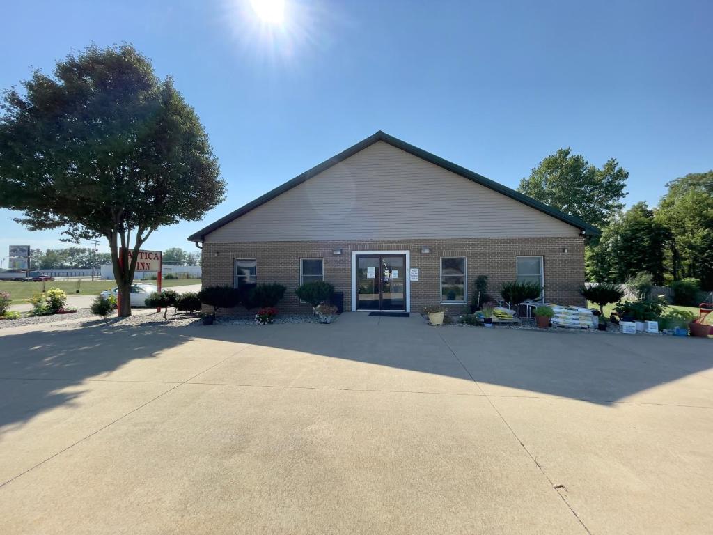 a large building with a driveway in front of it at Attica Inn in Attica