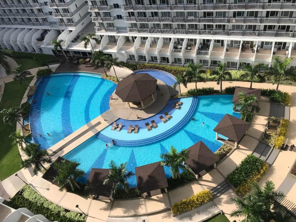 an overhead view of a large swimming pool in a resort at Shell Residences in Manila