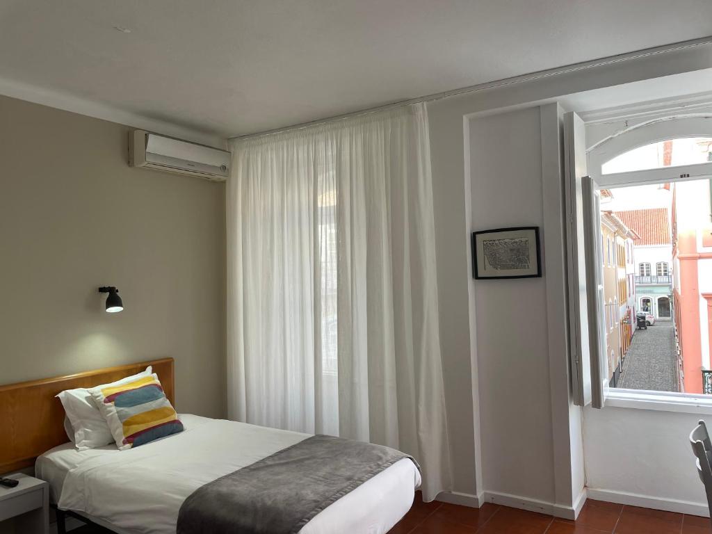 Postel nebo postele na pokoji v ubytování Hotel Ilha