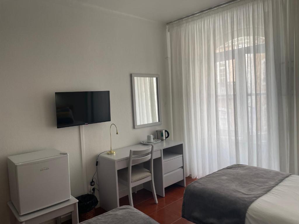 TV a/nebo společenská místnost v ubytování Hotel Ilha