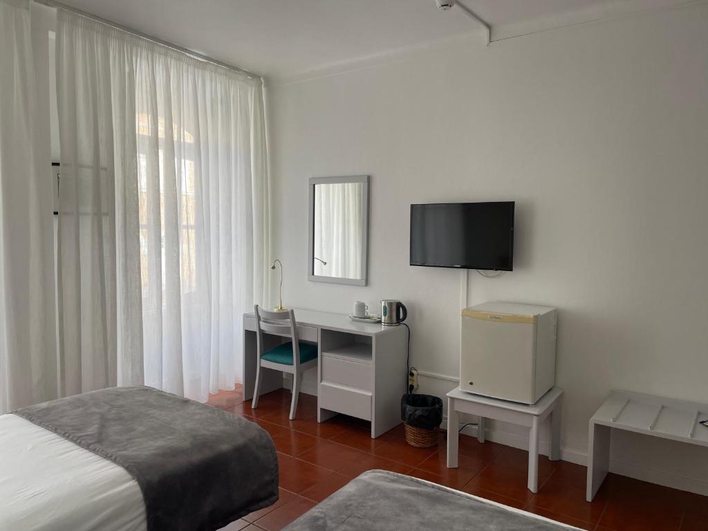 TV a/nebo společenská místnost v ubytování Hotel Ilha
