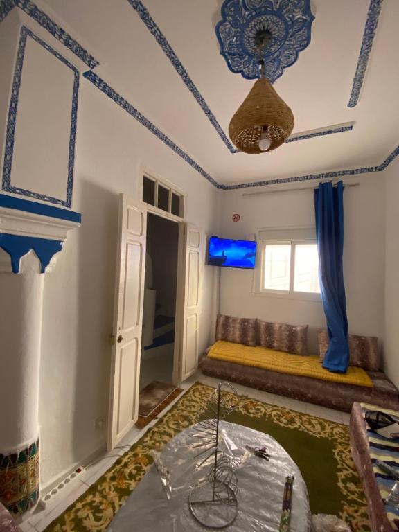 a room with a bed and a window at Ibn Batouta House in Tangier
