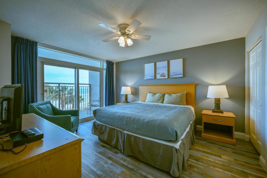 a bedroom with a bed and a tv and a window at A Piece of Paradise, Newly Renovated in Myrtle Beach