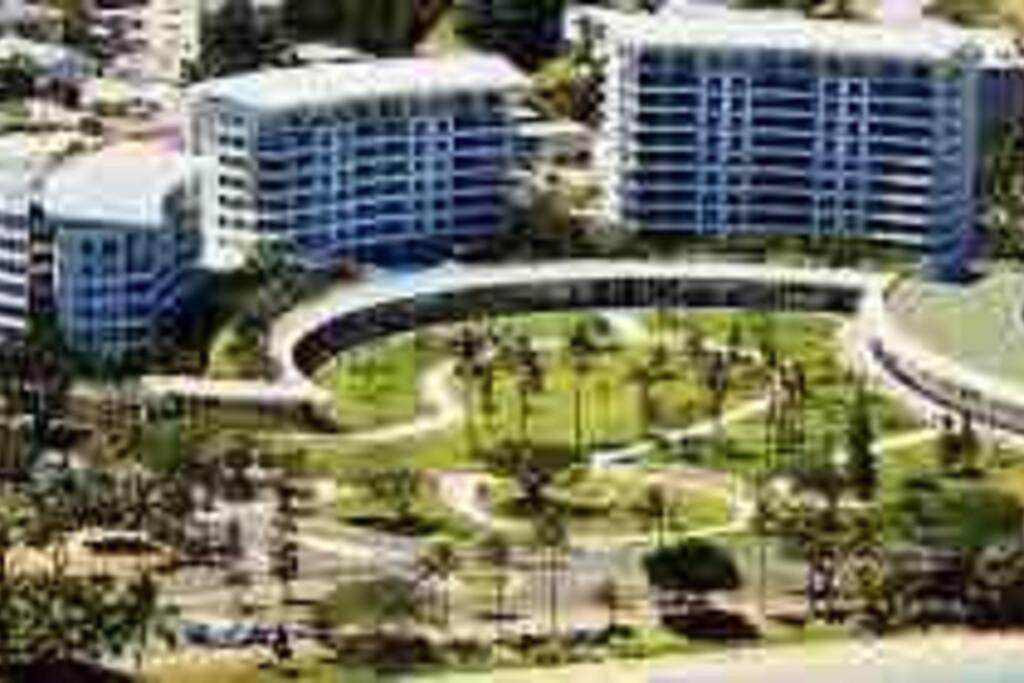 a view of a city with tall buildings and a bridge at The place to be in Noumea