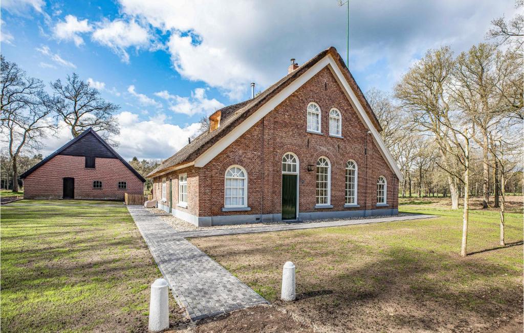 een grote bakstenen kerk met een grasveld bij 6 Bedroom Gorgeous Home In Nijverdal in Zuna