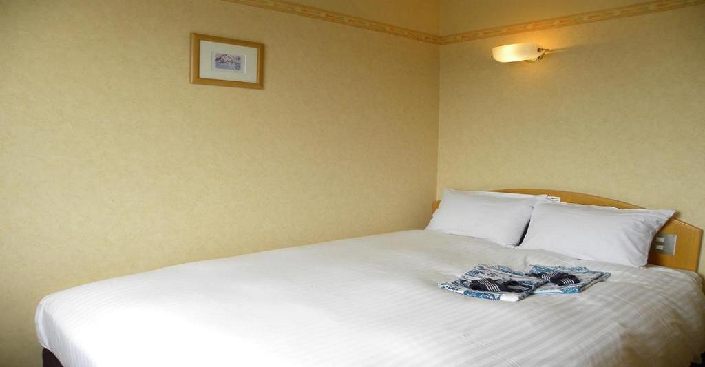 Un pat sau paturi într-o cameră la Yonezawa - Hotel / Vacation STAY 14342