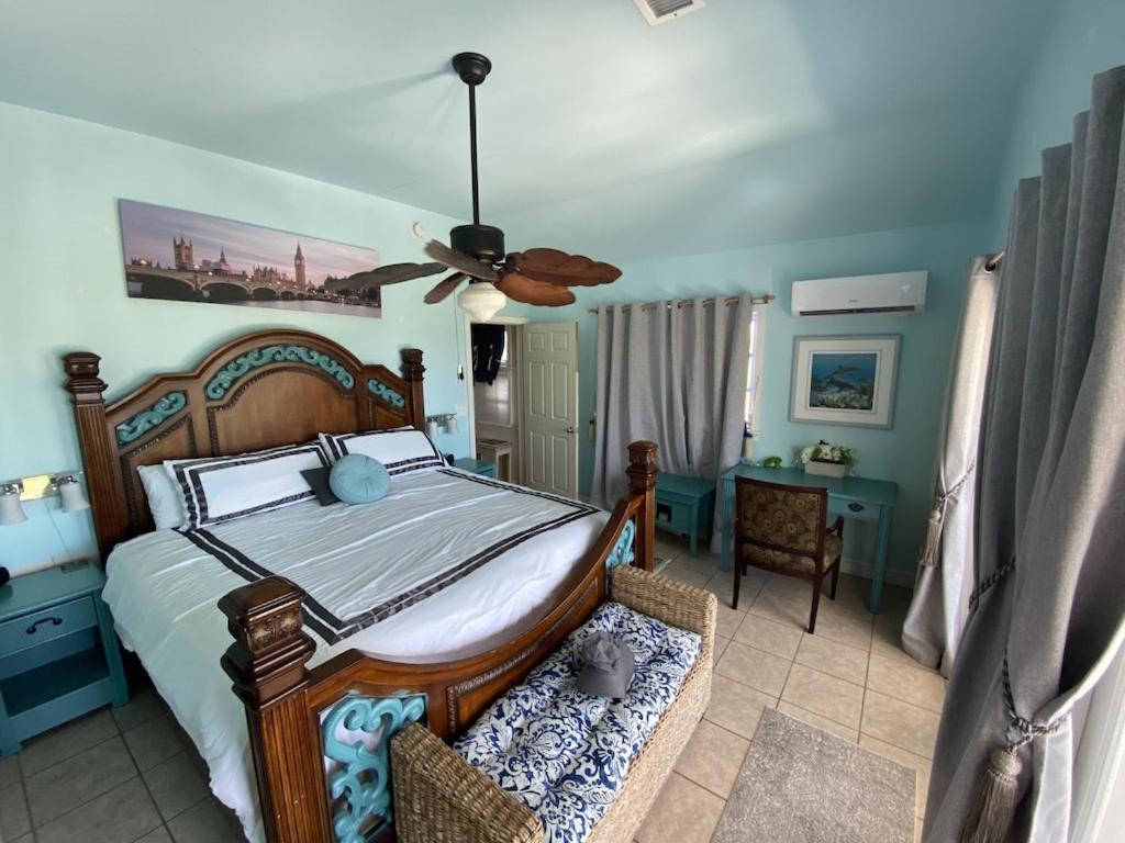 a bedroom with a bed and a ceiling fan at Private Estate Pool Ocean View 20 minutes to Key West in Summerland Key