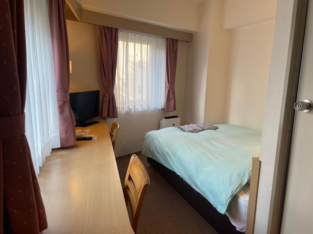 Postel nebo postele na pokoji v ubytování Olympic Inn Azabu