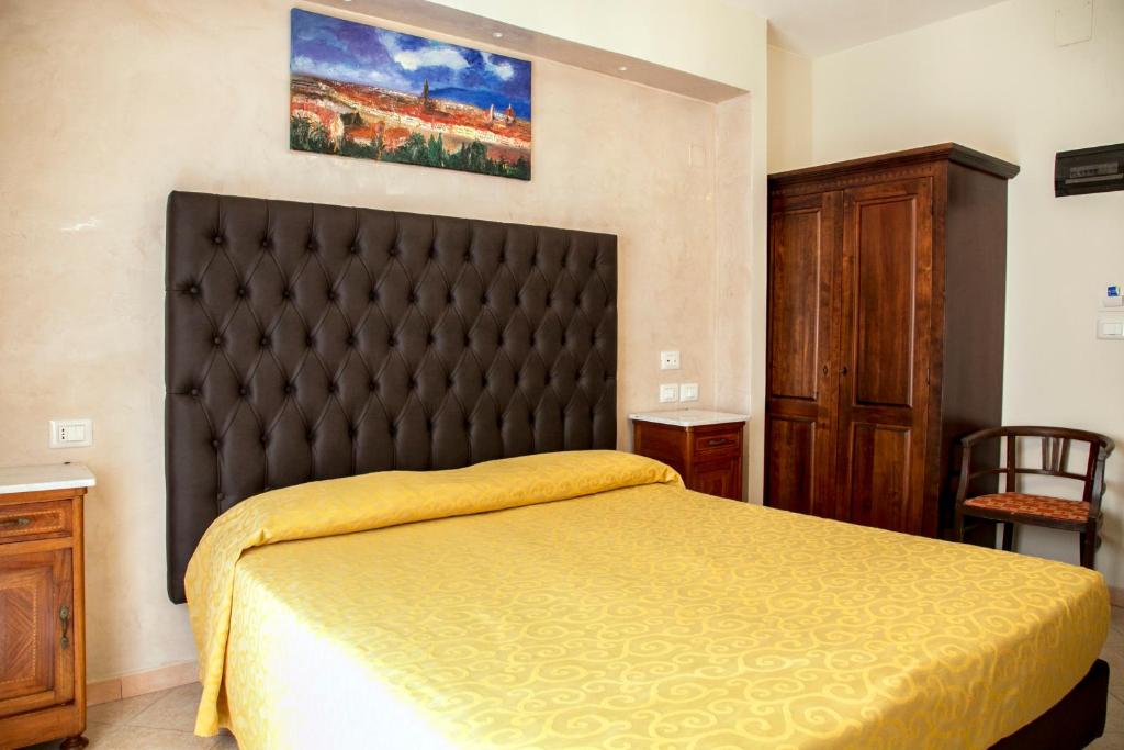 Postel nebo postele na pokoji v ubytování Hotel Merlini