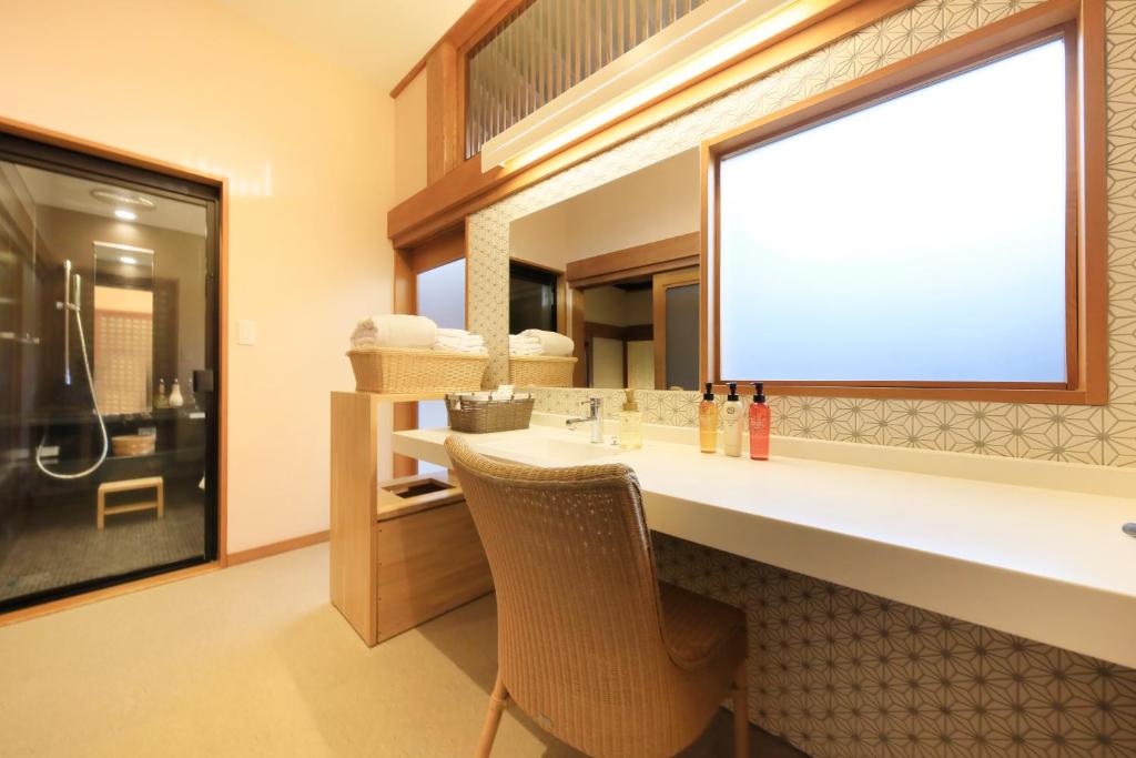 a bathroom with a sink and a mirror at Fuji Onsenji Yumedono in Fujikawaguchiko