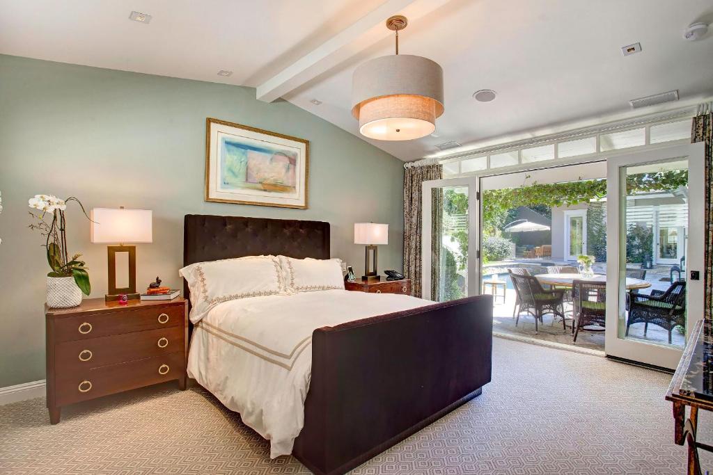 a bedroom with a bed and a table with a patio at Luxury Beverly Hills Suite in Beverly Hills
