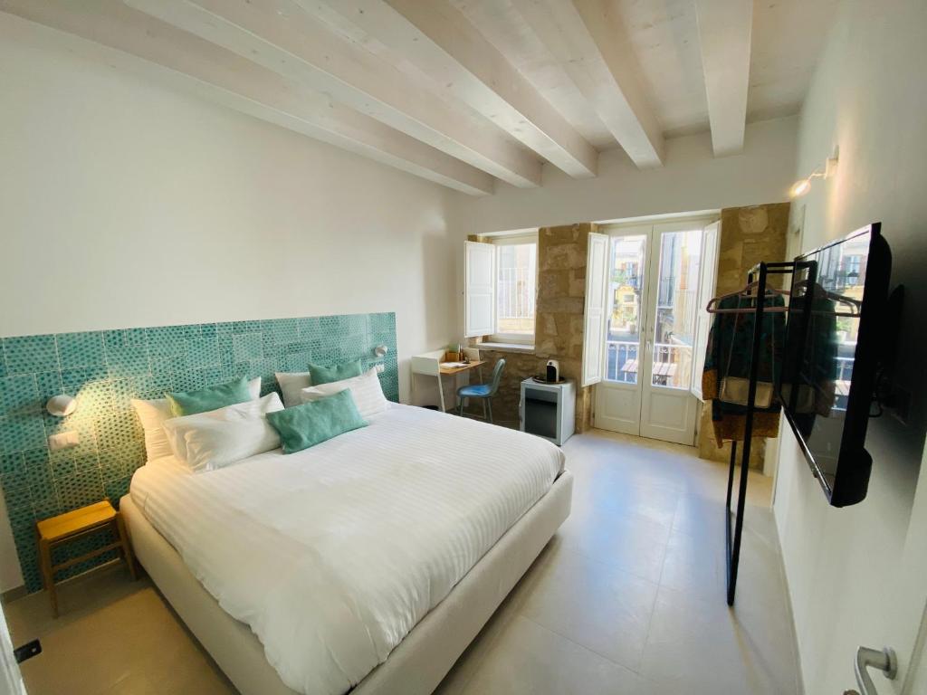 Ένα ή περισσότερα κρεβάτια σε δωμάτιο στο Residence Le Tre Grazie - Appartamento Tàlia