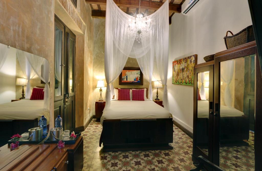 Postel nebo postele na pokoji v ubytování Villa Herencia Hotel