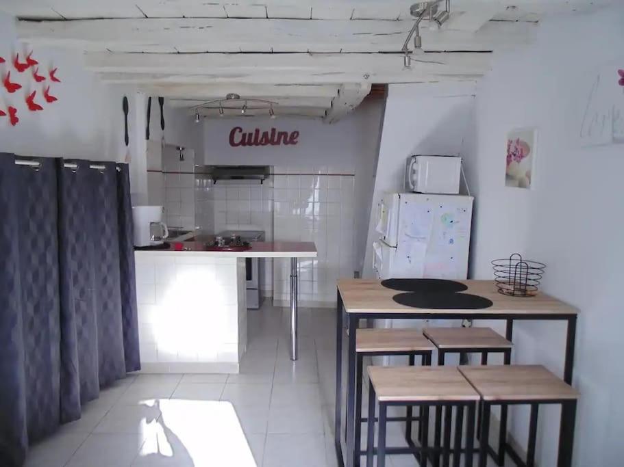 a kitchen with a table and a counter top at Le Gambetta - nouveau propriétaire in Estissac