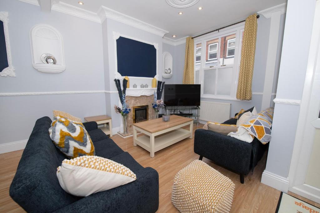 a living room with two couches and a tv at EmmaDale Bridington Town Centre Sleeps 10 in Bridlington