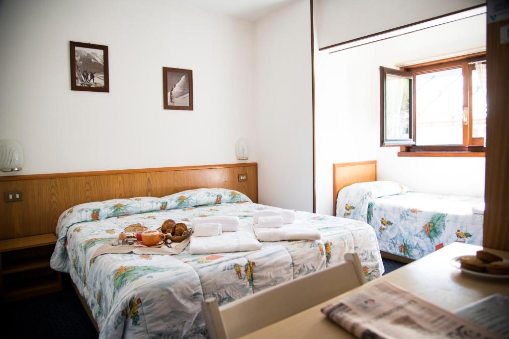 Postel nebo postele na pokoji v ubytování Hotel Marguareis