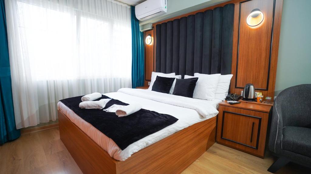 a bedroom with a large bed with towels on it at Lukka Suit Hotel in Istanbul