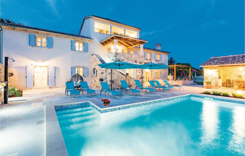 a house with a swimming pool in front of a house at Holiday Home Vodnjan With Fireplace I in Vodnjan