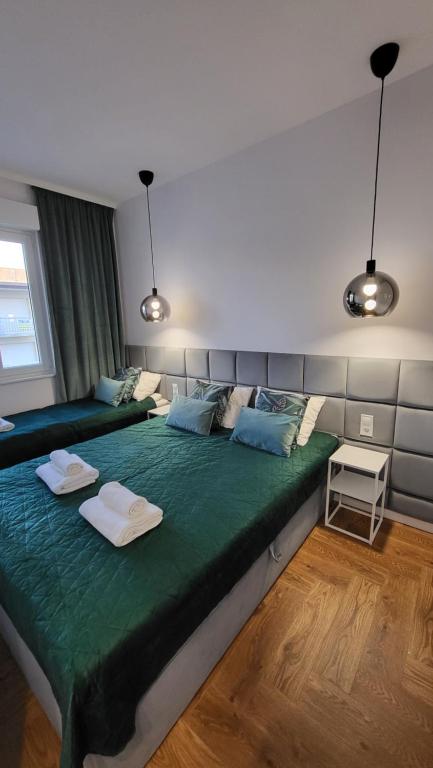 A bed or beds in a room at Malibu Apartments