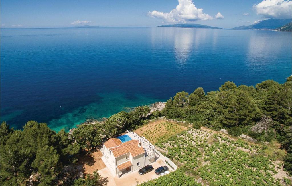 an aerial view of a house on the shore of a lake at Cozy Home In Dingac With Kitchen in Gornji Dingač