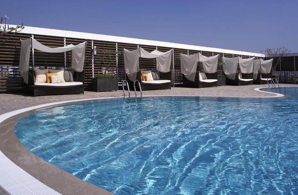 a large swimming pool with chairs and a building at Shangri-La Far Eastern Tainan in Tainan