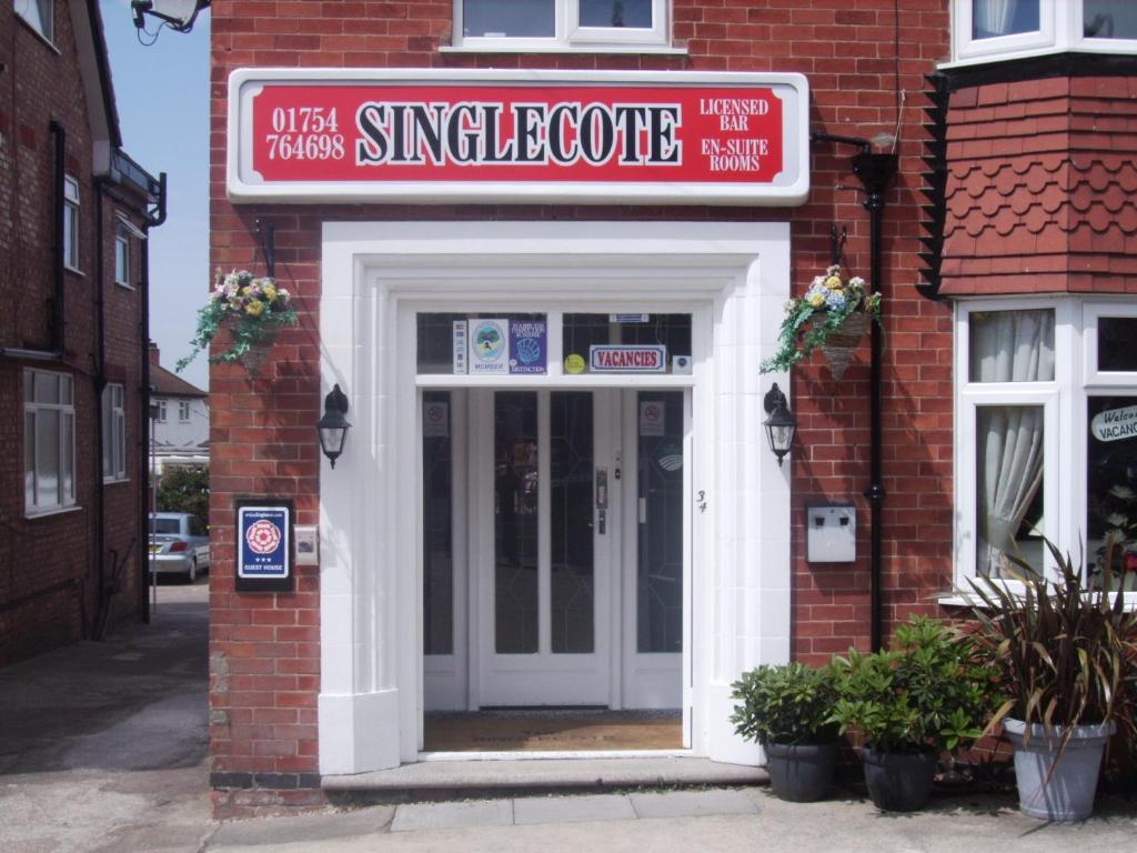 a entrance to a brick building with a sign over the door at Singlecote in Skegness