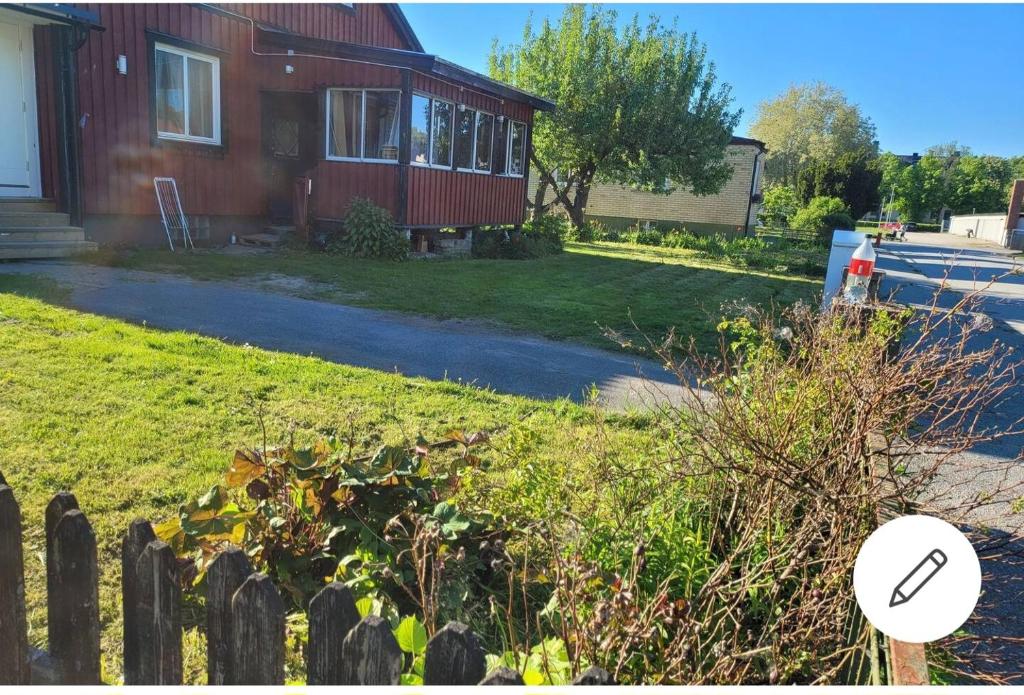 a house with a fence in front of a yard at 2 bed room Quite and central house in Orebro in Örebro
