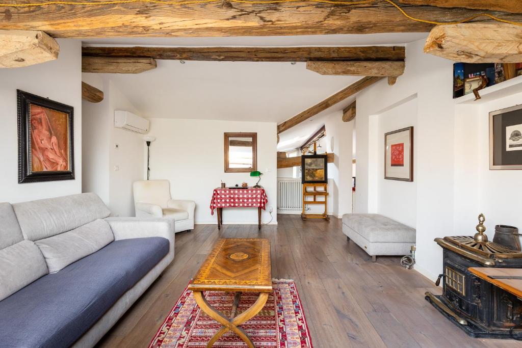 a living room with a couch and a table at Italy prestigious historical attic in Bologna in Bologna
