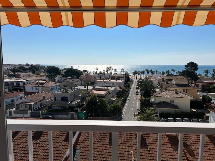 a view of a city from a balcony at Apartamento con vistas al mar in Cambrils