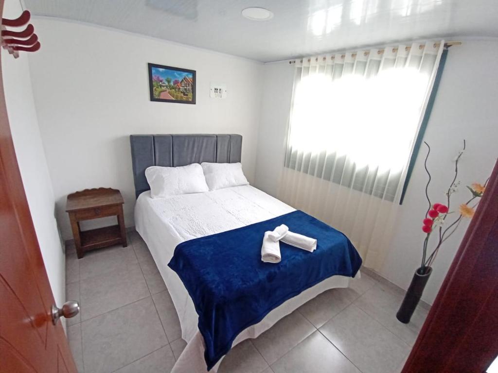 Voodi või voodid majutusasutuse ApartaHotel Monguí toas