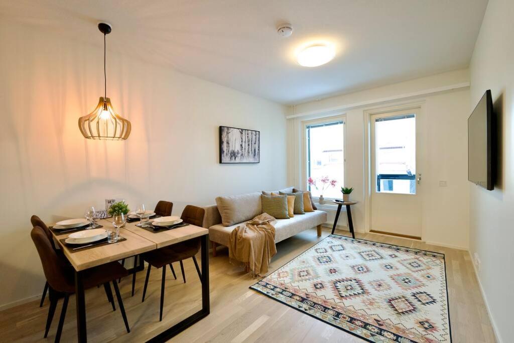 - un salon avec une table et un canapé dans l'établissement Brandnew Modern Condo with Sauna, à Rovaniemi