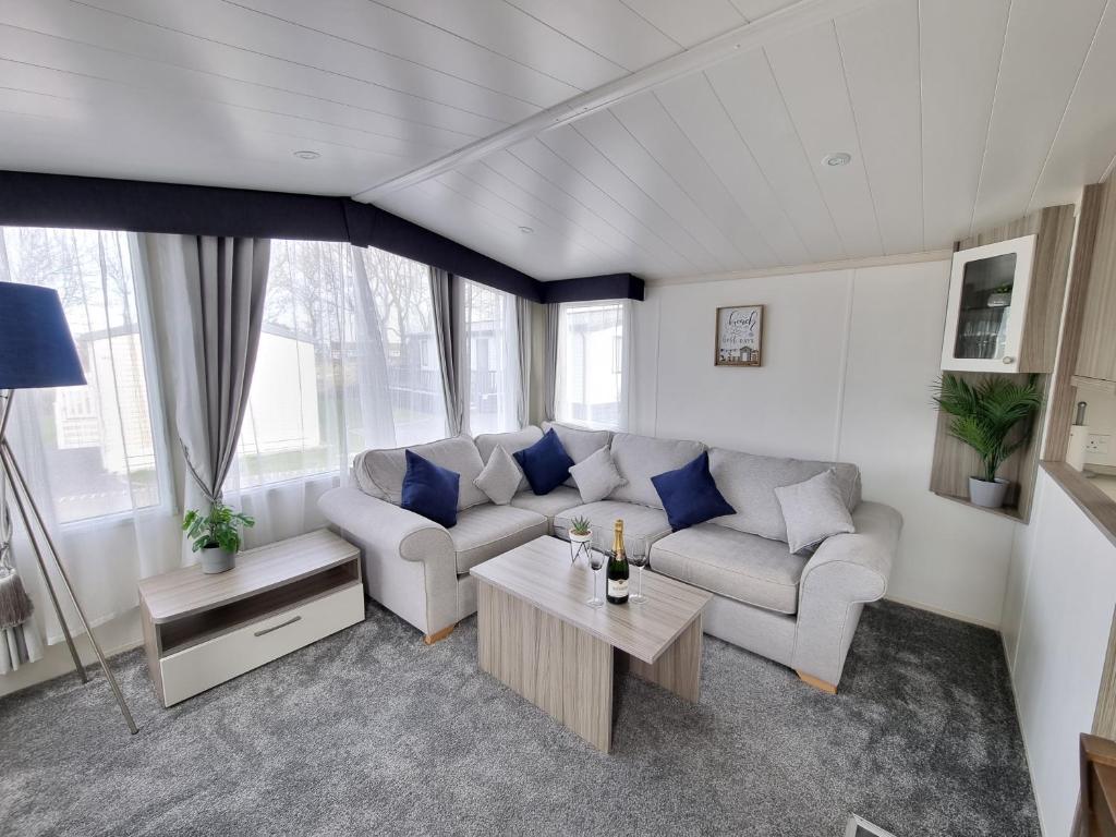 a living room with a couch and a table at Seven Sunsets, Padstow in Padstow