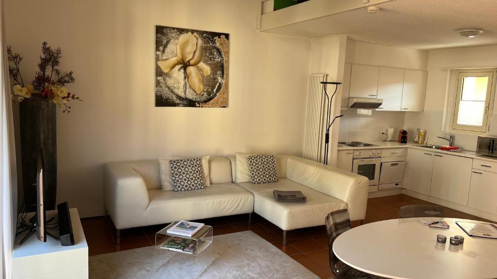 a living room with a couch and a table at AsconaDolceVita in Ascona