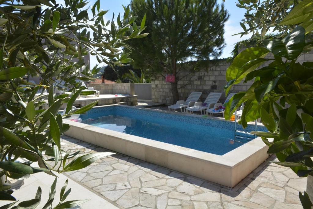 a swimming pool in a yard with trees at Villa Avantgarde in Mlini